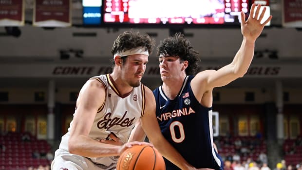 Boston College Eagles forward Quinten Post (12) drives the ball against Virginia Cavaliers forward Blake Buchanan (0) during the second half at Conte Forum.